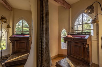 Chambre Amazone : fenêtres en ogive sur la verdure et pupitre ancien en bois