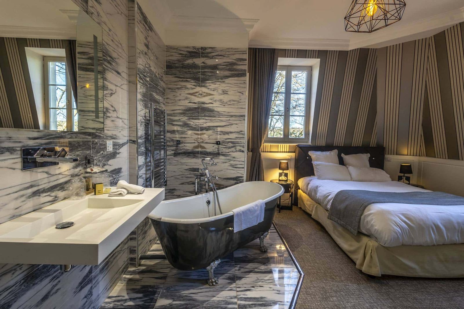 Chambre Coquine : baignoire sur pieds et coin toilette en marbre dans la chambre, murs rayés